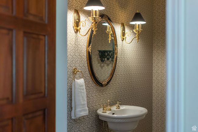 Bathroom featuring a sink and a chandelier | Image 43