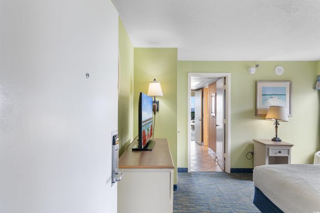 Carpeted bedroom featuring tile patterned floors and baseboards | Image 22