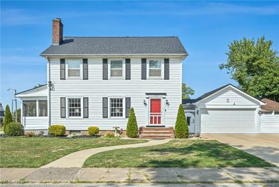 Colonial inspired home with a garage and a front lawn | Image 2