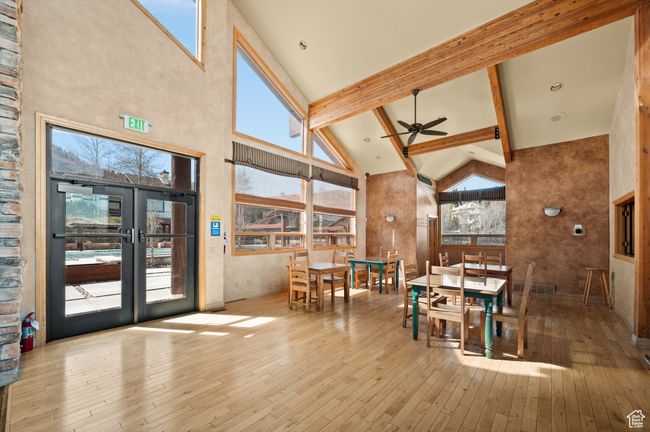 Clubhouse: Community Dining room featuring a ceiling fan, high vaulted ceiling, and hardwood / wood-style flooring | Image 37