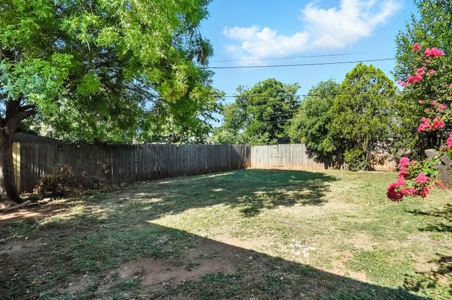 View of fenced backyard | Image 23