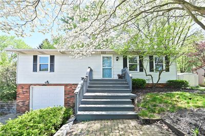 View of front of house with a storage unit and a garage | Image 1