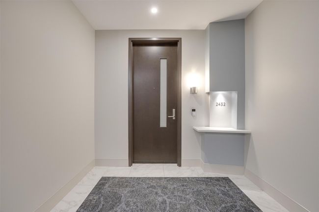 Foyer featuring elevator, light marble finish floors, and recessed lighting | Image 4