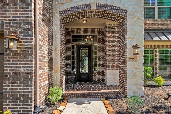 Beautiful details as you enter the home from the inviting front porch with a bench ready to be decorated. | Image 5