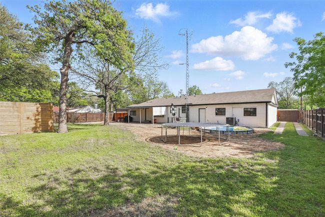 Rear view of house with a trampoline | Image 39