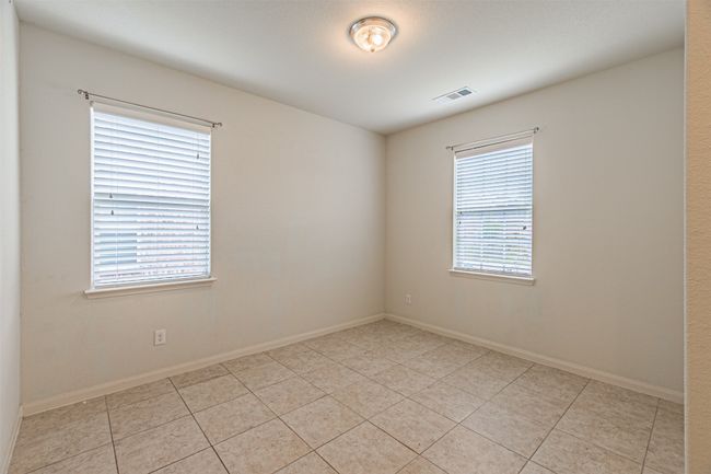 Spare room featuring light tile patterned flooring and baseboards | Image 5