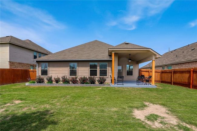 Back of property featuring ceiling fan, a patio area, and roof with shingles | Image 22