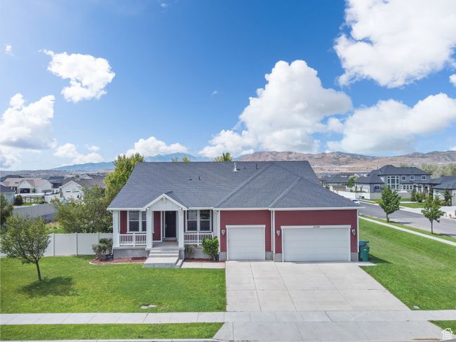 View of front of home with a garage, covered porch, a mountain view, driveway, and roof with shingles | Image 39