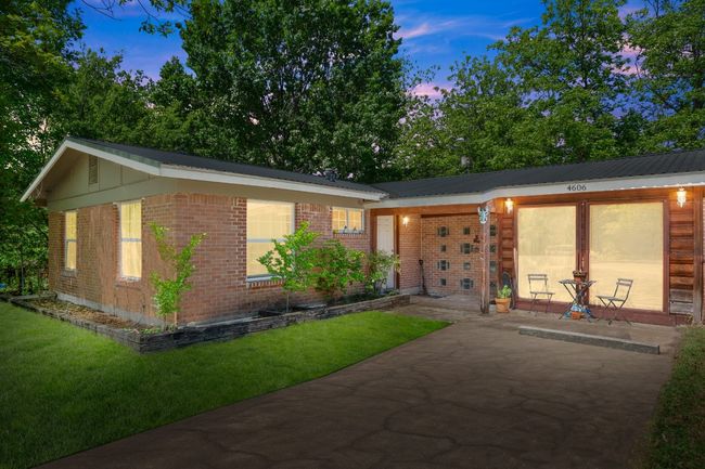 Ranch-style home featuring metal roof, a patio, a yard, and brick siding | Image 24