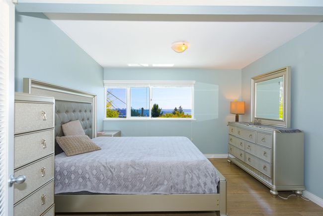 Bedroom with baseboards and dark wood-style floors | Image 17