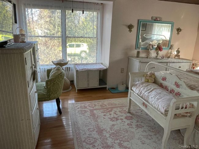Bedroom with wood-type flooring | Image 8