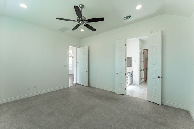 Unfurnished bedroom featuring light carpet, lofted ceiling, recessed lighting, and ceiling fan | Image 24