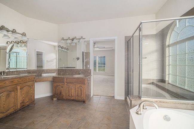 Full bathroom with a shower stall, vanity, a bath, and a ceiling fan | Image 32