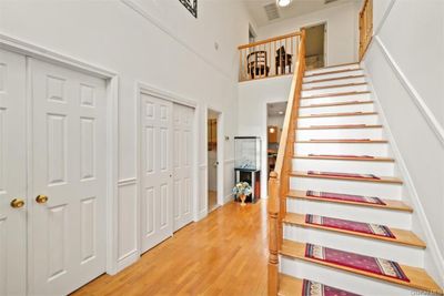 Stairway with a towering ceiling and wood-type flooring | Image 3