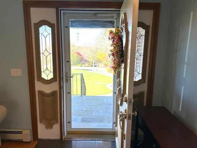 Foyer entrance featuring a baseboard radiator | Image 5