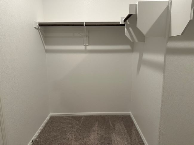 Spacious closet with carpet floors | Image 6