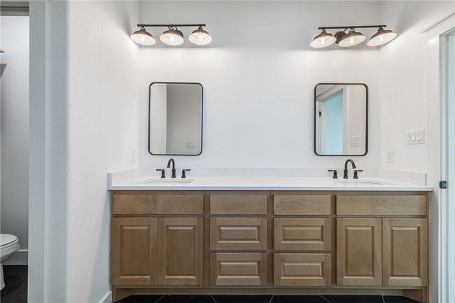 Bathroom with toilet, vanity, and tile patterned floors | Image 17