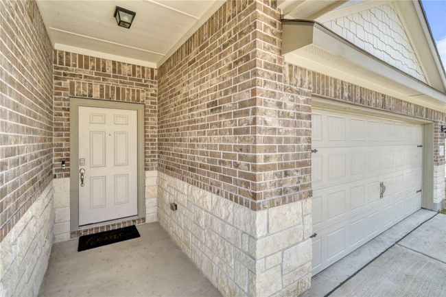 View of exterior entry featuring a garage | Image 5