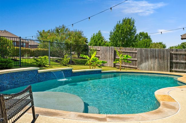 Gorgeous pool with shallow section for tanning or little kids. Peep that waterfall! | Image 28