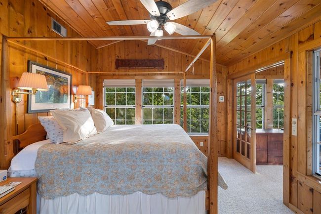 Elevated Owner's Retreat: Ascending to the loft-style primary bedroom, the owners are welcomed into a refined sanctuary that seamlessly blends comfort and functionality. This private space also encompasses a gracious sitting area and a dedicated office space. | Image 19