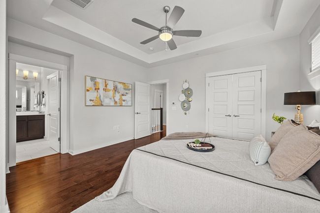 The tray ceiling adds a touch of elegance to the primary bedroom, while the ceiling fan ensures year-round comfort and a cool breeze on warm nights | Image 26