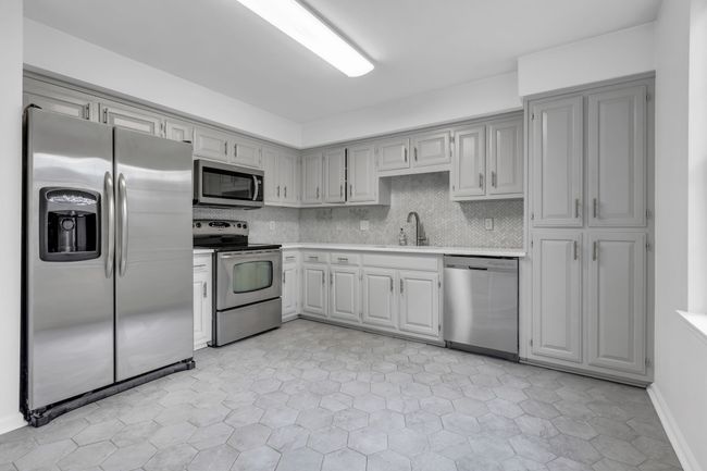 Kitchen updates include painted cabinets, new tile floors, beautiful granite countertops and tile backsplash. | Image 8