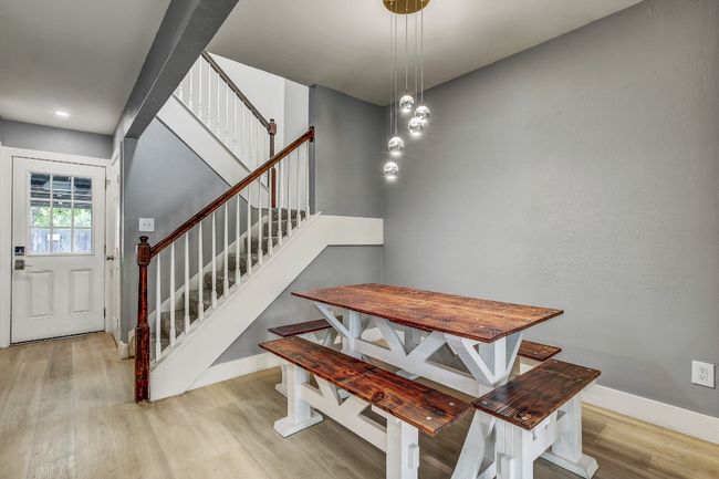 Dining space featuring wood finished floors, stairway, baseboards, and recessed lighting | Image 7