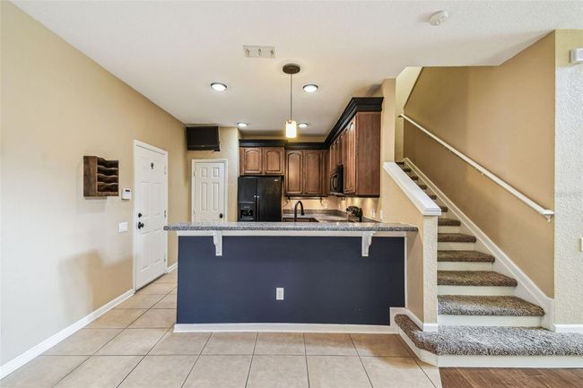 The kitchen boasts 42-inch cabinets with elegant crown molding and granite countertops. | Image 7