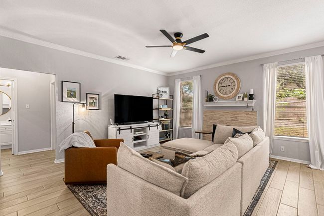 Bright and open living room, steps from a full bathroom in the hallway | Image 8