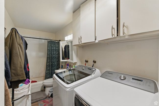 Washroom with separate washer and dryer and laundry area | Image 27
