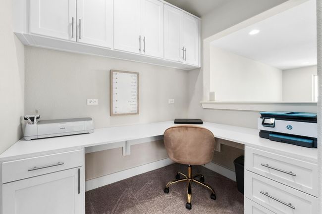Office space off the game room featuring a built in desk and cabinets | Image 26