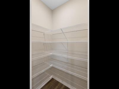 PHOTO OF A DIFFERENT HOME WITH SIMILAR PLAN & FINISHES. Kitchen corner pantry shelving offers added storage. Photo may not depict actual plan, materials, & finishes. | Image 3