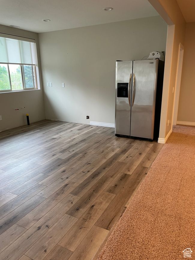 Kitchen with stainless steel fridge and wood finished floors | Image 15