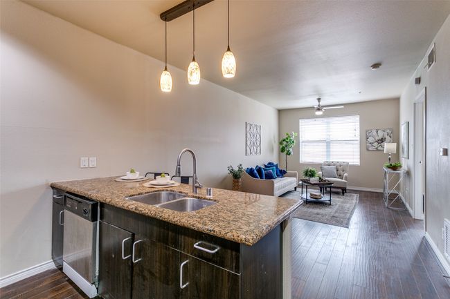 Kitchen with dishwashing machine, dark wood-style floors, dark brown cabinetry, a ceiling fan, and a peninsula | Image 7