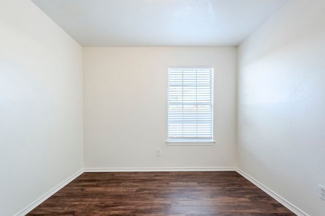 Spare room featuring dark wood finished floors | Image 25