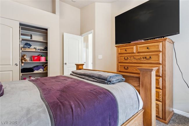 Bedroom with carpet flooring, baseboards, and a closet | Image 25