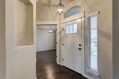 Entryway featuring a notable chandelier and dark wood-type flooring | Image 2