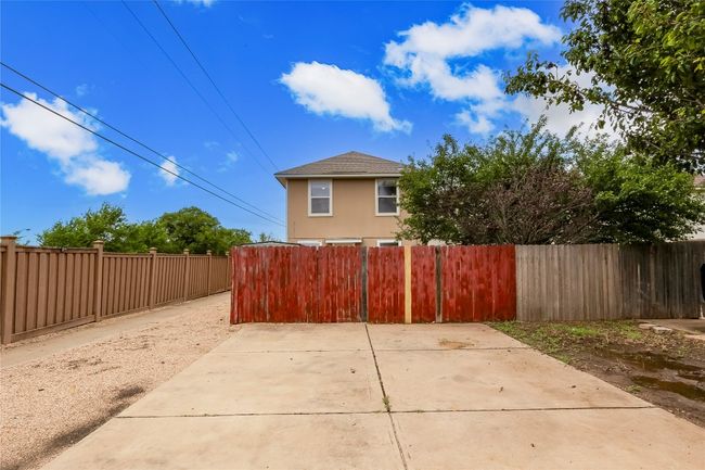 View of property exterior with roof with shingles | Image 24