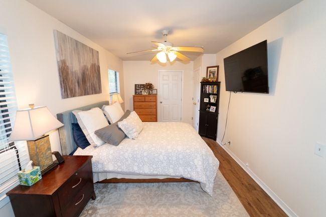 Bedroom with wood finished floors and a ceiling fan | Image 32