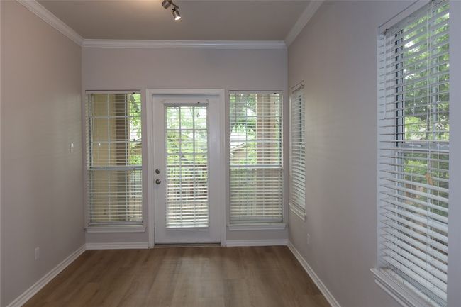 Entryway with wood finished floors, baseboards, and crown molding | Image 9