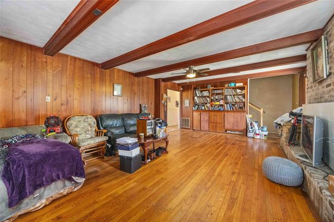 The real hard wood floors and wood beams show this home was built with style. | Image 10