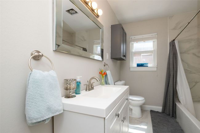 Full bath featuring shower / tub combo, toilet, vanity, and baseboards | Image 33