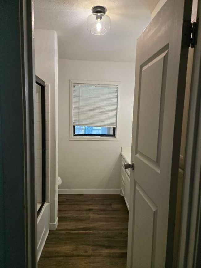 Corridor featuring dark wood finished floors and baseboards | Image 12
