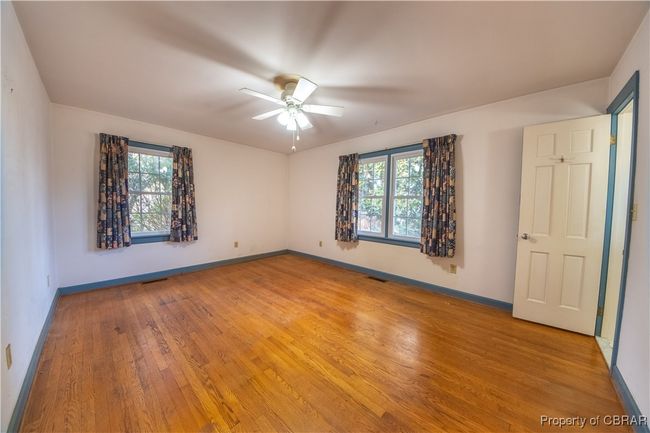 Unfurnished bedroom with ceiling fan, multiple windows, and light wood-type flooring | Image 19