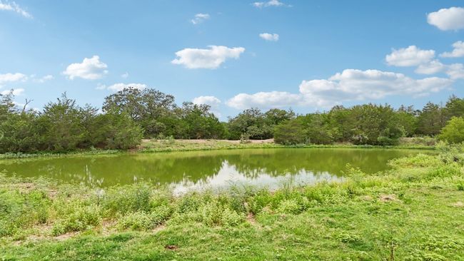 Water view featuring a heavily wooded area | Image 26