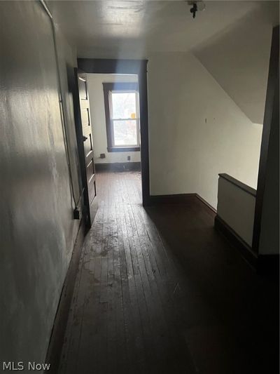 Corridor with dark hardwood / wood-style floors and lofted ceiling | Image 3