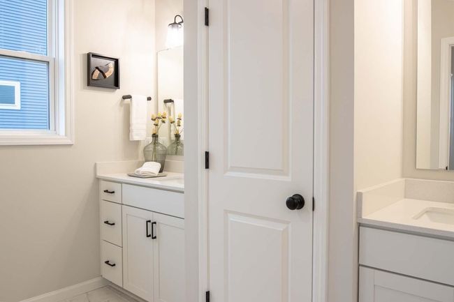 The en-suite bathroom features separate dual sinks, offering ample space and convenience for both partners. Photos are from previously built home; options and features will vary. | Image 18