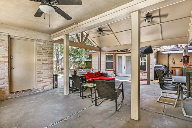 Walking in from side gate by garage - beautiful covered patio and guest suite straight ahead. | Image 5