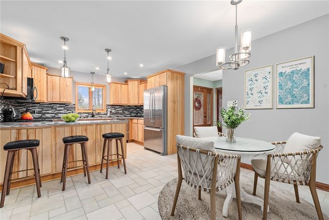 Beautifully updated kitchen with recessed lighting, back splash and stainless appliances | Image 7