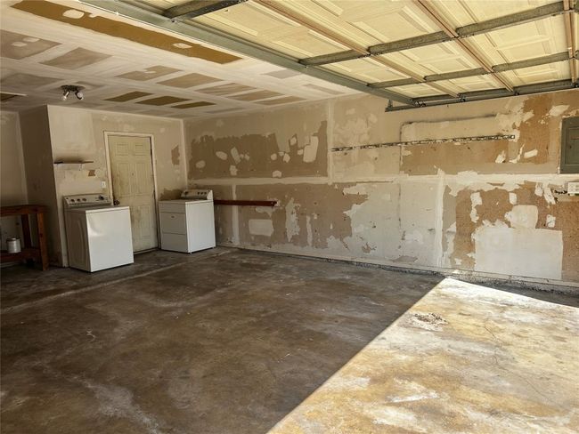 Garage featuring washer / dryer and electric panel | Image 20